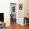 living room with tv and view of kitchen