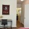 bedroom with bed desk and wall art