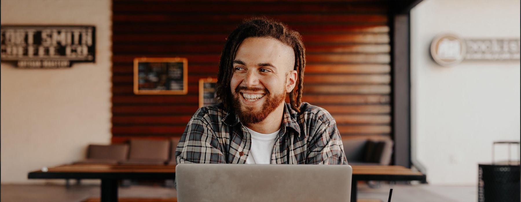 lifestyle image of a man smiling in a warm-toned room